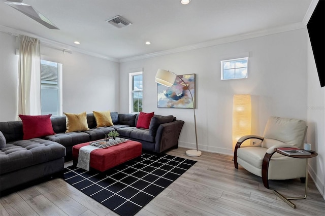 living room featuring ornamental molding and light hardwood / wood-style floors