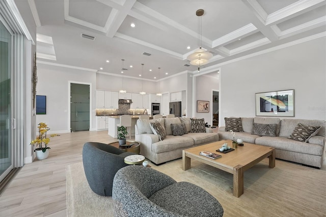 living room featuring coffered ceiling, ornamental molding, light wood-type flooring, and beam ceiling