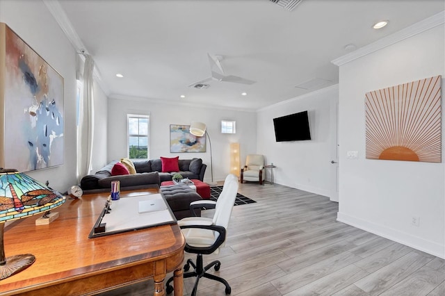 home office with ornamental molding and light hardwood / wood-style floors