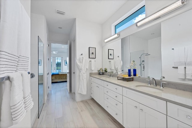 bathroom featuring hardwood / wood-style flooring, vanity, a healthy amount of sunlight, and an enclosed shower