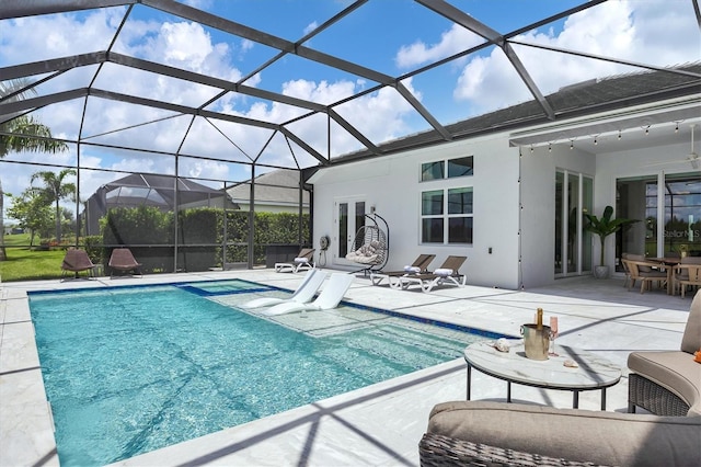 view of swimming pool with a patio area and a lanai