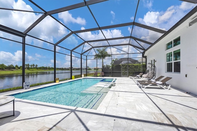 view of pool with a lanai, a water view, and a patio