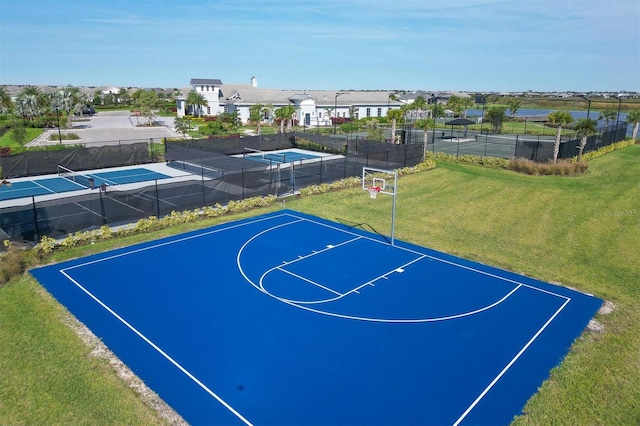 view of sport court with a lawn