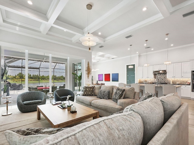 living room with crown molding, coffered ceiling, light wood-type flooring, and beam ceiling