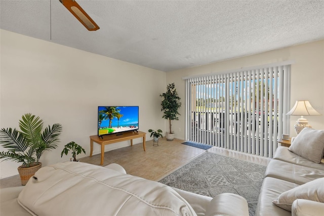 living room featuring tile patterned floors and a textured ceiling