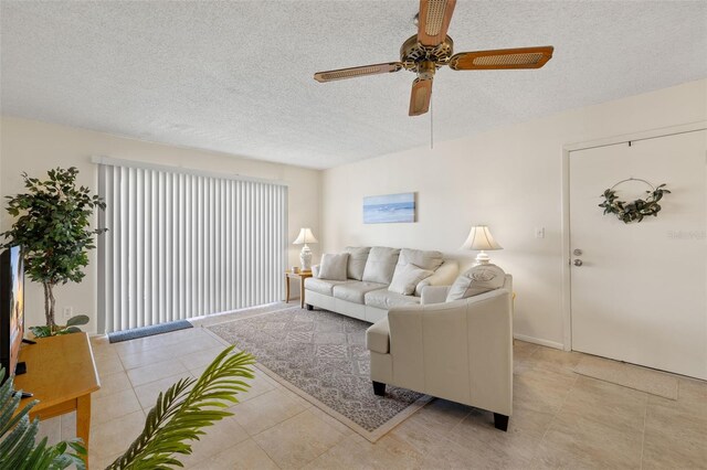 tiled living room with a textured ceiling and ceiling fan