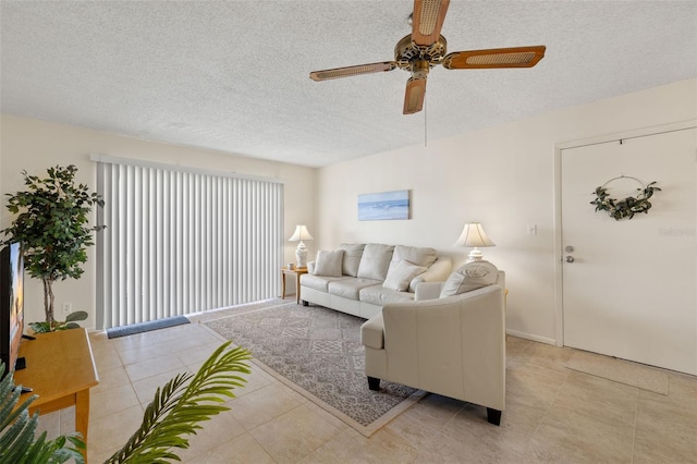 tiled living room featuring ceiling fan and a textured ceiling