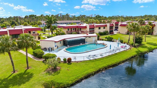 exterior space featuring a water view, a lawn, and a patio area