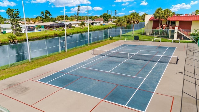 view of sport court featuring a water view