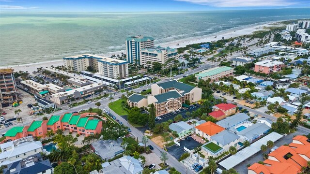 drone / aerial view featuring a water view and a view of the beach