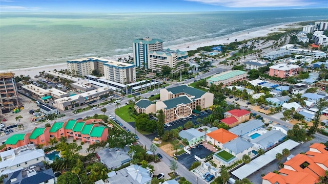 birds eye view of property with a water view, a view of the beach, and a city view