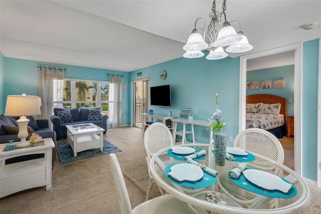 dining space featuring an inviting chandelier and carpet