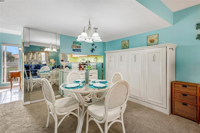 carpeted dining space featuring a chandelier and a textured ceiling