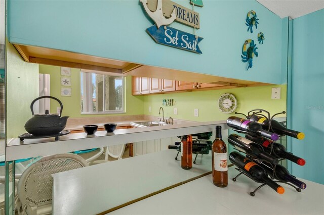 kitchen with tile patterned floors, sink, and light brown cabinets