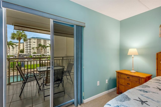 bedroom featuring access to exterior and light colored carpet