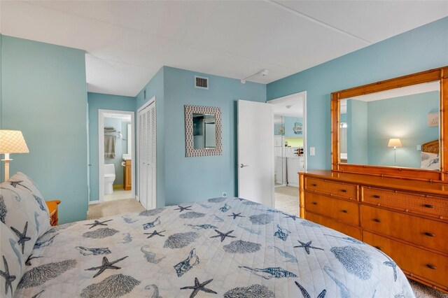 carpeted bedroom featuring a closet and connected bathroom