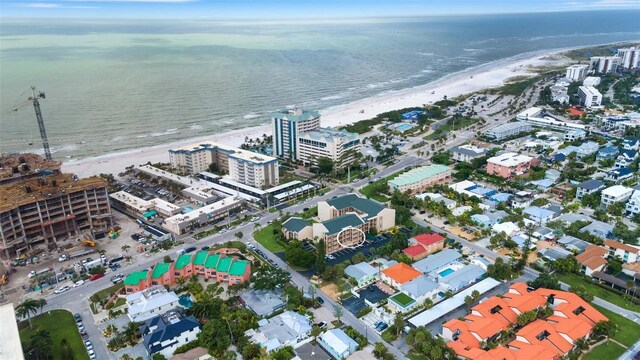 bird's eye view with a water view and a beach view