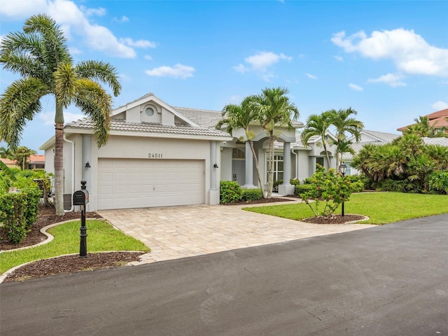 view of front of property featuring a garage and a front lawn