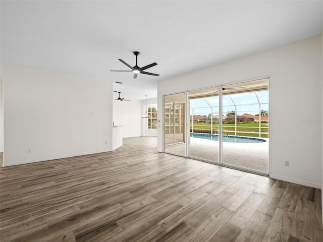 unfurnished living room featuring wood-type flooring and ceiling fan