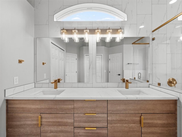 bathroom with an enclosed shower and dual bowl vanity