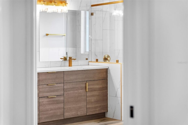 bathroom with vanity, an enclosed shower, and hardwood / wood-style floors