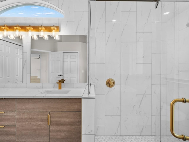 bathroom with vanity and a tile shower