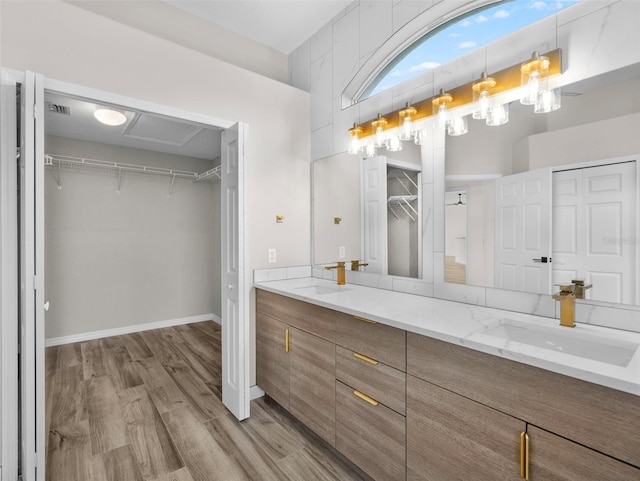 bathroom featuring hardwood / wood-style flooring and dual bowl vanity