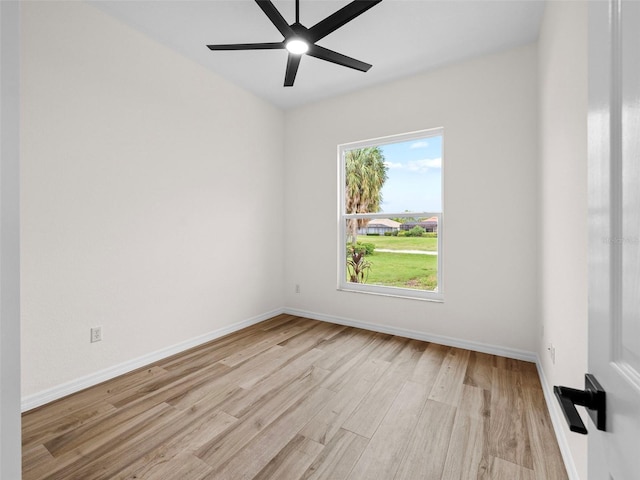 spare room featuring a wealth of natural light, ceiling fan, and light hardwood / wood-style floors