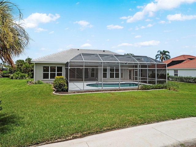 rear view of property featuring a yard and a lanai