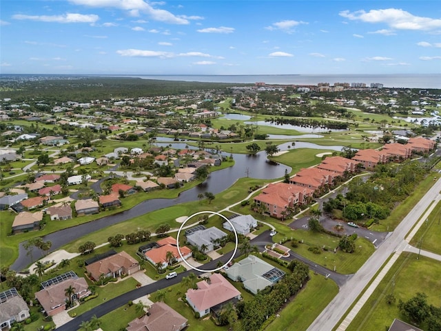 birds eye view of property with a water view