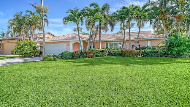 view of front of property featuring a garage and a front lawn