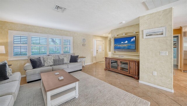 tiled living room with a textured ceiling