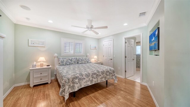 bedroom with light hardwood / wood-style flooring, a closet, ceiling fan, connected bathroom, and ornamental molding