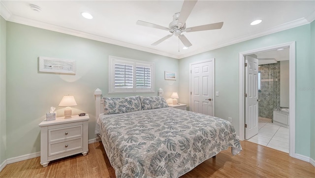 bedroom featuring ceiling fan, ornamental molding, ensuite bathroom, and light wood-type flooring