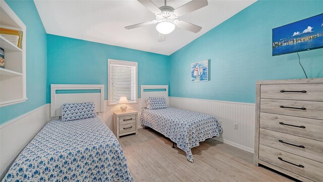 bedroom with lofted ceiling, ceiling fan, and light hardwood / wood-style floors