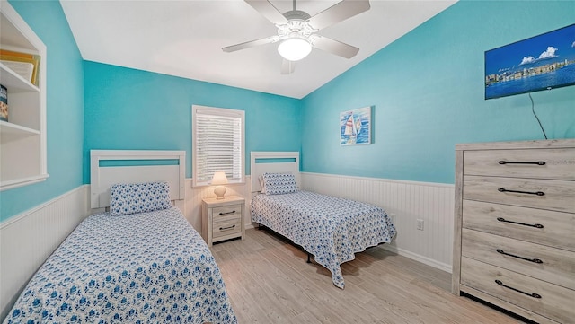 bedroom with vaulted ceiling, ceiling fan, and light wood-type flooring