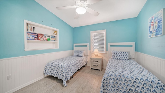 bedroom featuring light wood-type flooring, ceiling fan, and lofted ceiling