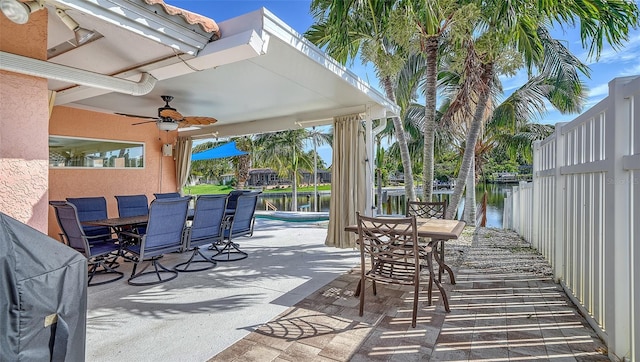 view of patio featuring ceiling fan and a water view