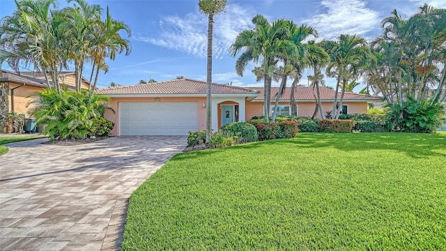 view of front of property featuring a garage and a front yard