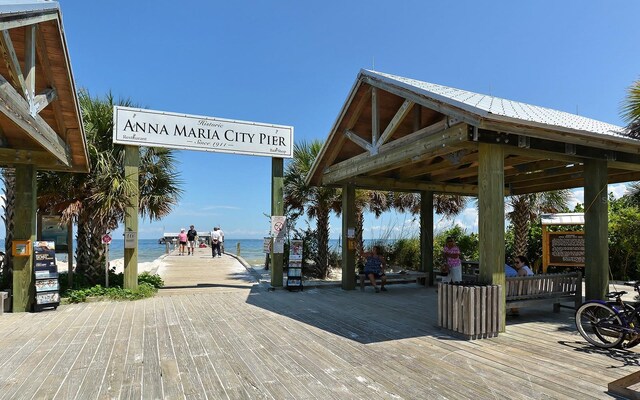 exterior space with a water view, a view of the beach, and a gazebo