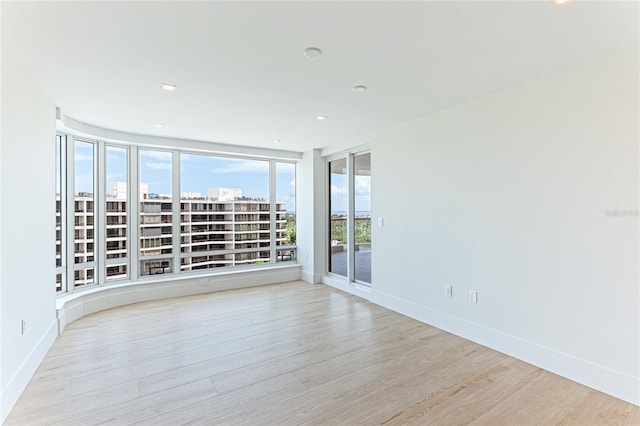 unfurnished room with light hardwood / wood-style floors