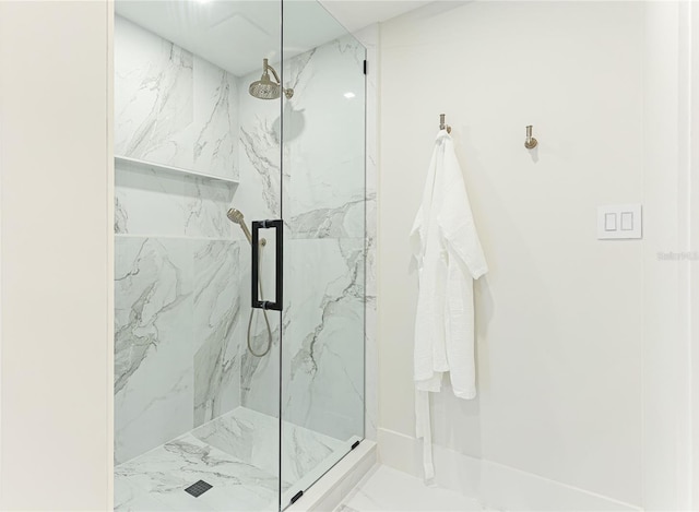 bathroom with tile patterned floors and a shower with door