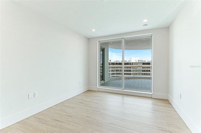 unfurnished room with light wood-type flooring