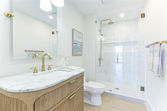 bathroom featuring vanity, walk in shower, tile patterned flooring, and toilet