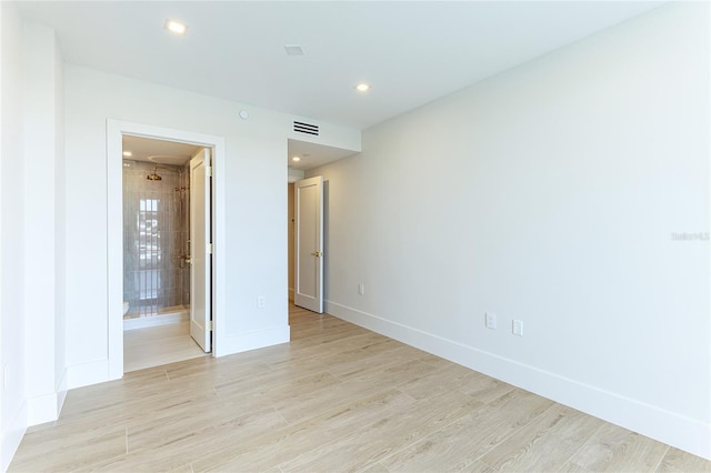 spare room with light hardwood / wood-style flooring