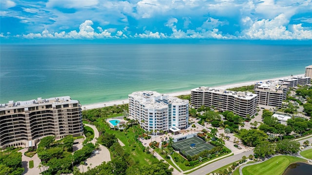 birds eye view of property featuring a water view and a beach view