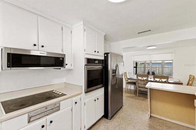 kitchen with white cabinetry and appliances with stainless steel finishes