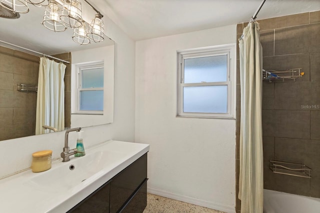 bathroom featuring a notable chandelier, shower / bath combo, and vanity