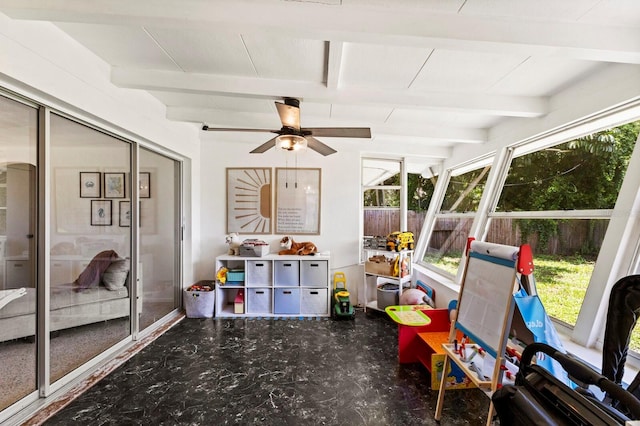 sunroom with ceiling fan and beam ceiling