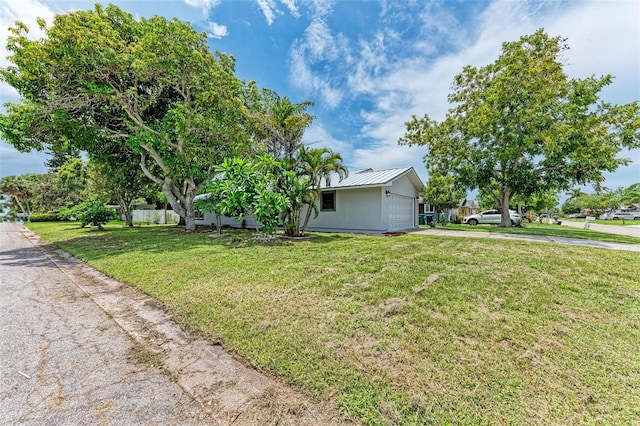 ranch-style house with a garage and a front yard